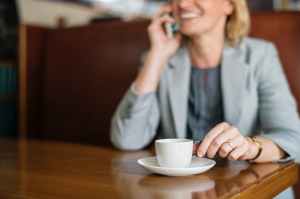 woman talking to phone white drinking coffee