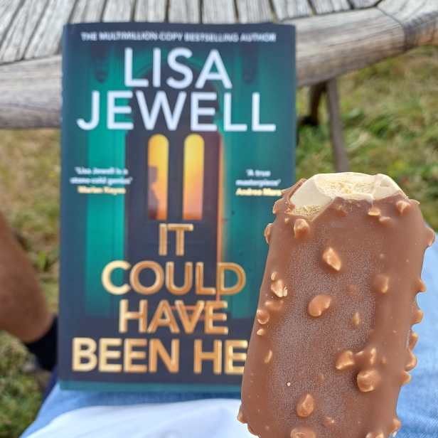 A photo of a chocolate ice-cream in front of a hardback copy of It Could Have Been Her by Lisa Jewell 